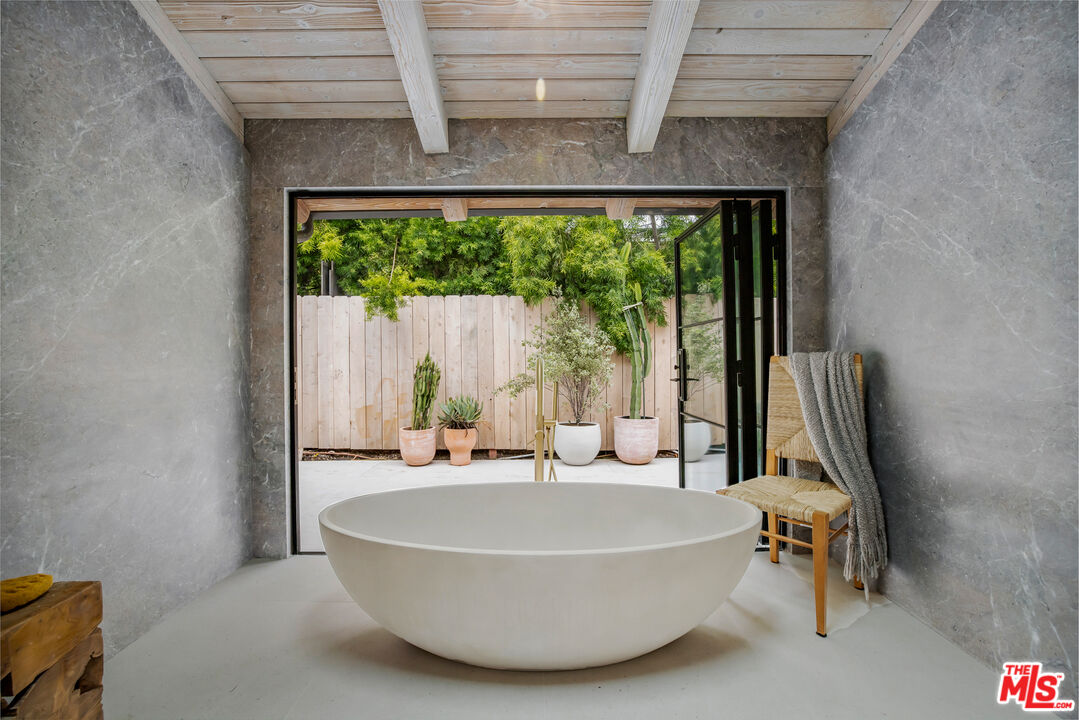 1508 Old Oak Road Los Angeles, CA 90049 - Photo 22 of 63 a white bath tub sitting in a bathroom next to a window