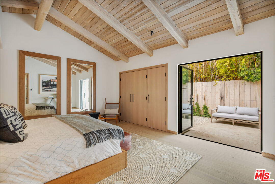 1508 Old Oak Road Los Angeles, CA 90049 - Photo 29 of 63 a spacious bedroom with a bed and a large window