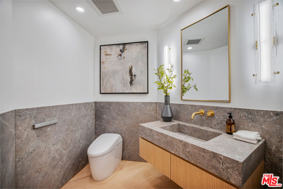 1508 Old Oak Road Los Angeles, CA 90049 - Photo 32 of 63 a bathroom with a toilet sink and mirror