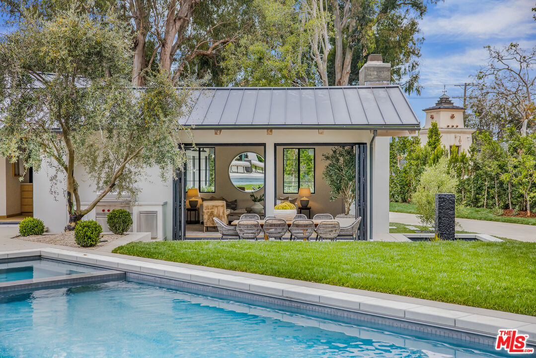 1508 Old Oak Road Los Angeles, CA 90049 - Photo 36 of 63 a front view of a house with garden and porch