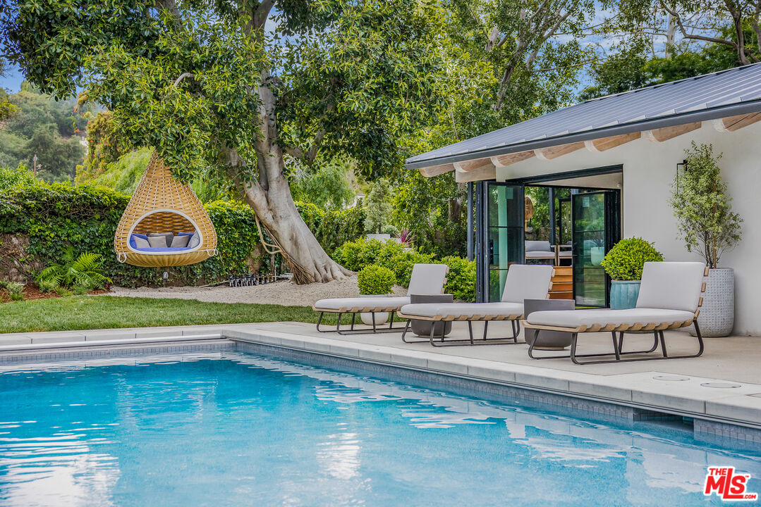 1508 Old Oak Road Los Angeles, CA 90049 - Photo 39 of 63 swimming pool view with a seating space and garden view