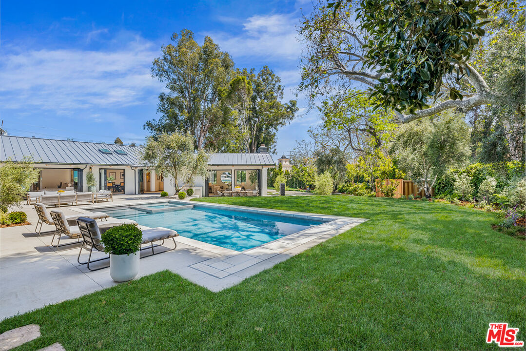 1508 Old Oak Road Los Angeles, CA 90049 - Photo 43 of 63 a front view of a house with garden and sitting area