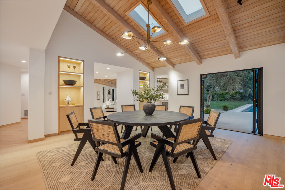 1508 Old Oak Road Los Angeles, CA 90049 - Photo 53 of 63 a view of a dining room with furniture window and wooden floor