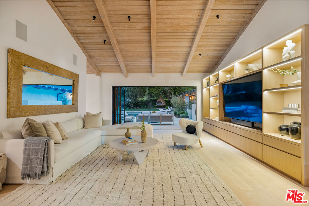 1508 Old Oak Road Los Angeles, CA 90049 - Photo 56 of 63 a living room with furniture a large window and wooden floor