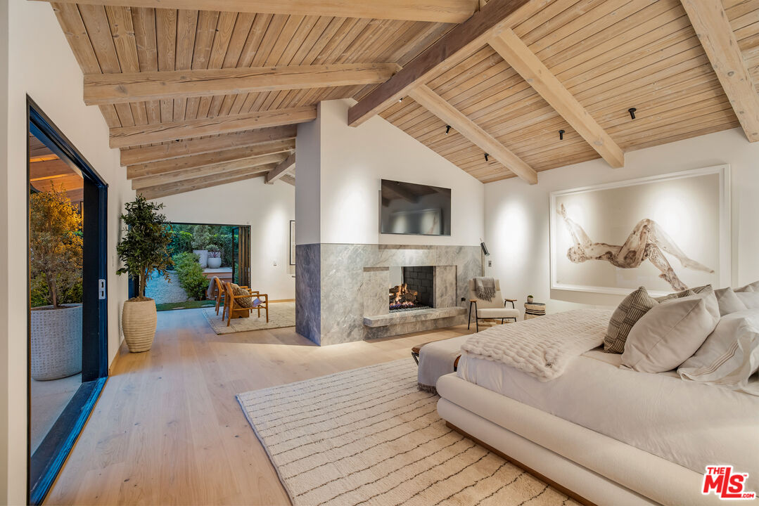 1508 Old Oak Road Los Angeles, CA 90049 - Photo 57 of 63 a living room with furniture a fireplace and a flat screen tv