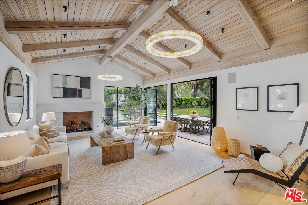1508 Old Oak Road Los Angeles, CA 90049 - Photo 7 of 63 a living room with furniture a fireplace and a large window