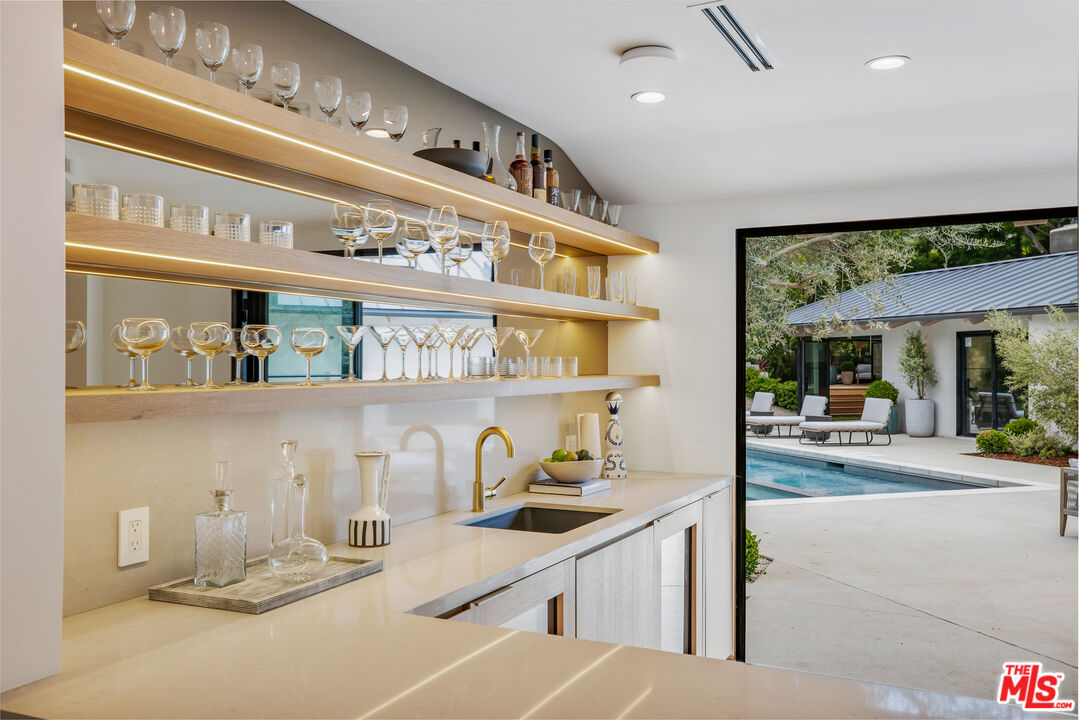 1508 Old Oak Road Los Angeles, CA 90049 - Photo 9 of 63 a kitchen with a sink and a clock on the wall