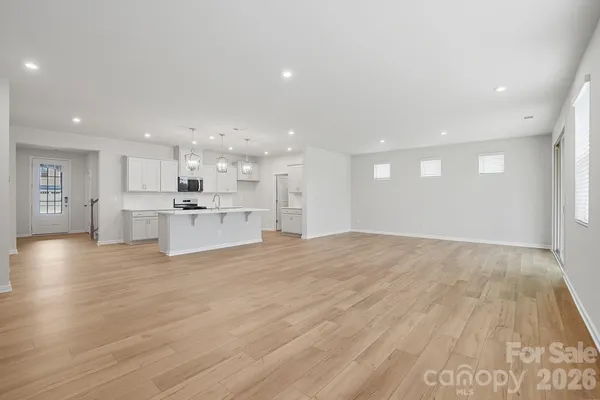 a view of kitchen with wooden floor and windows