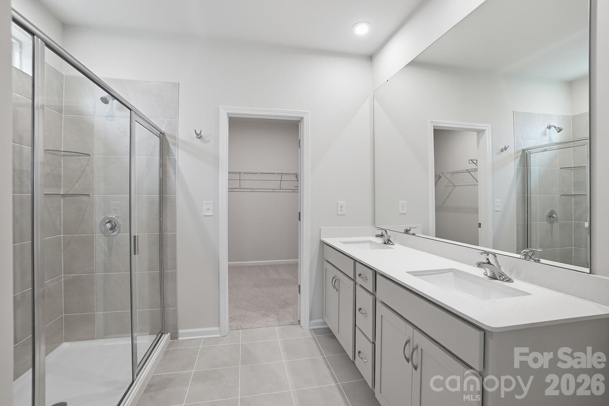 1505 Miriam Way Monroe, NC 28112 - Photo 16 of 29 a bathroom with a double vanity sink mirror and shower