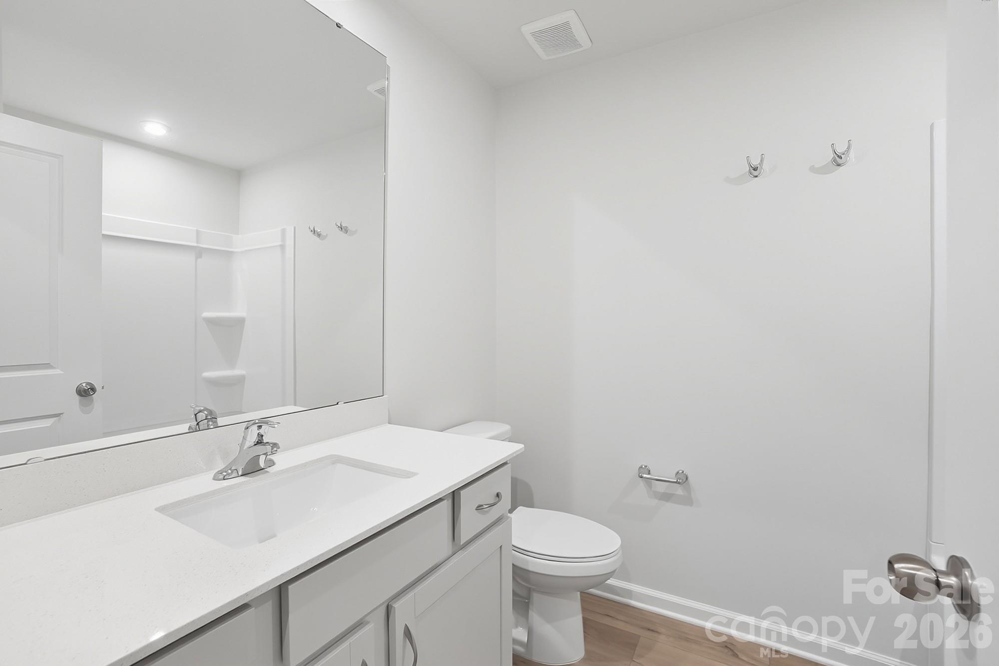 1505 Miriam Way Monroe, NC 28112 - Photo 23 of 29 a bathroom with a sink toilet and vanity