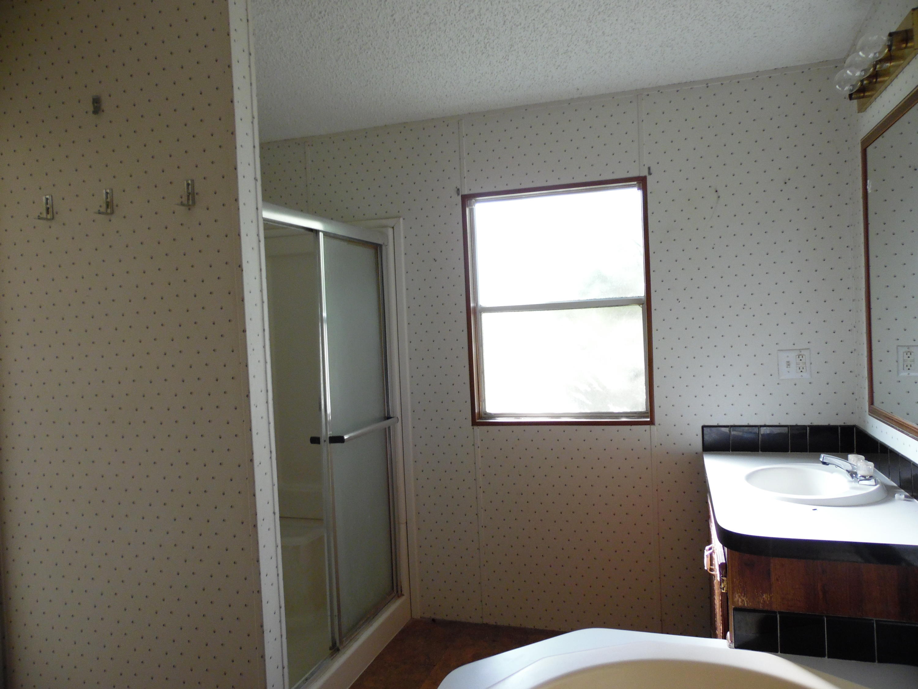 723 Squirrel Road DeFuniak Springs, FL 32433 - Photo 16 of 33 a bathroom with a toilet a sink and a window