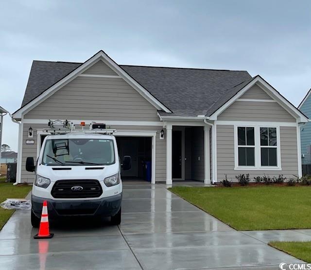 View of front of home featuring a garage and a fro