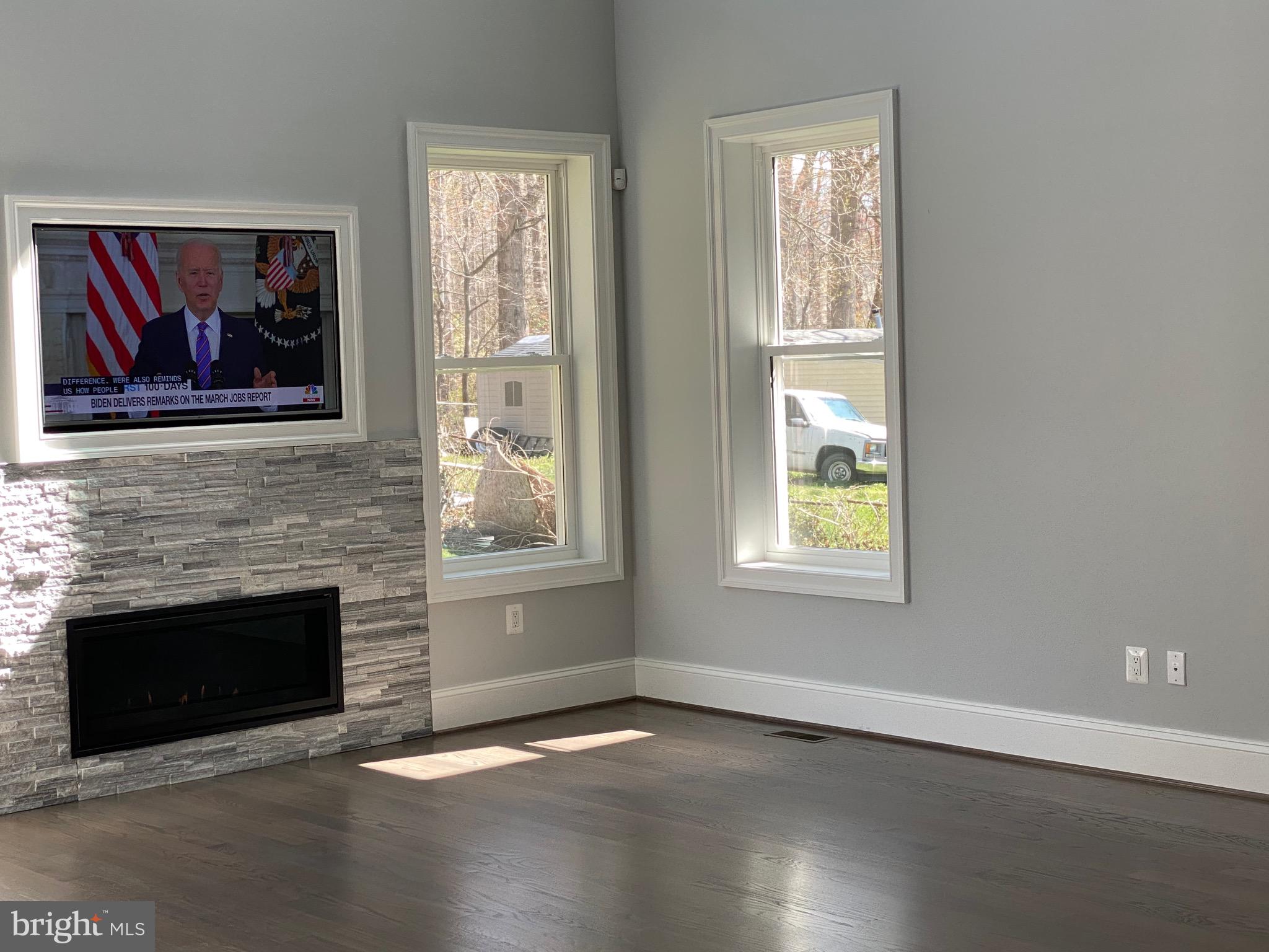 8712 Redman Street Springfield, VA 22153 - Photo 3 of 77 Mounted TV - and sleek gas fireplace with stone