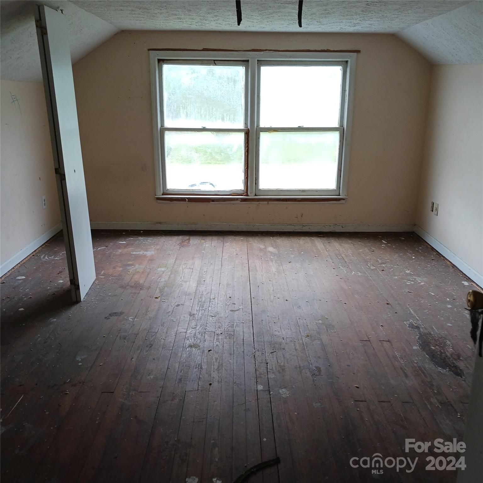 3116 Highway 70 Morganton, NC 28655 - Photo 11 of 13 an empty room with wooden floor and windows