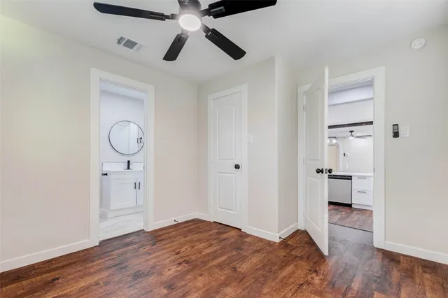 a view of empty room with wooden floor