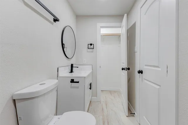 a bathroom with a toilet sink and a mirror