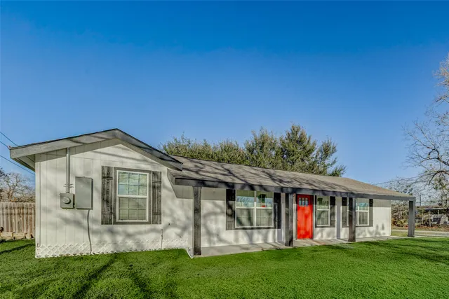 a front view of a house with a yard and porch