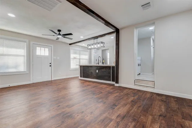 wooden floor in an empty room with a window