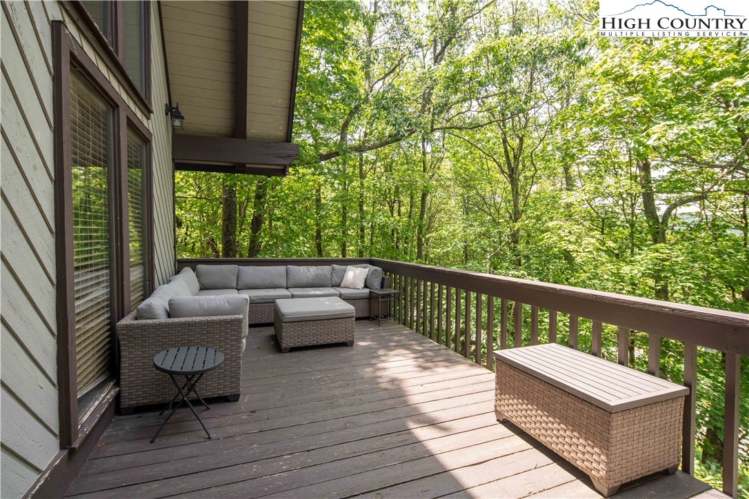 111 Pinnacle Ridge Road Beech Mountain, NC 28604 - Photo 11 of 50 a balcony with wooden floor and furniture