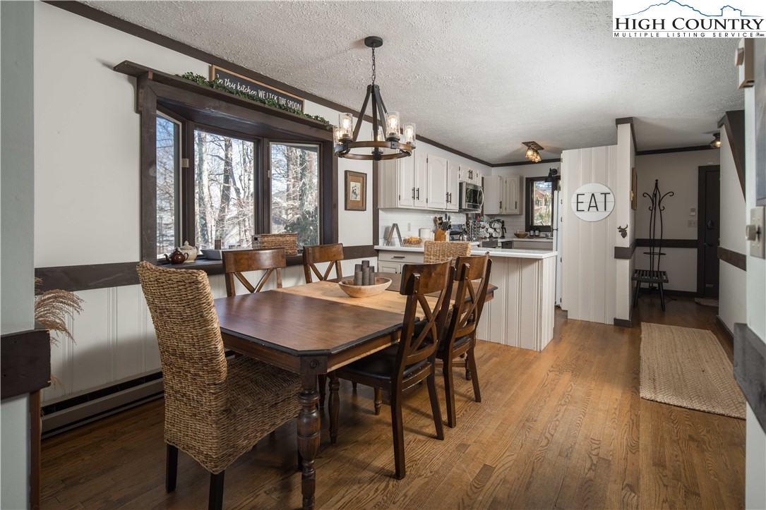 111 Pinnacle Ridge Road Beech Mountain, NC 28604 - Photo 14 of 50 a view of a a dining room with furniture window and wooden floor