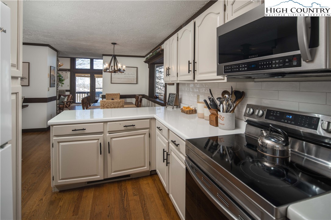 111 Pinnacle Ridge Road Beech Mountain, NC 28604 - Photo 18 of 50 a kitchen with a sink stove and microwave