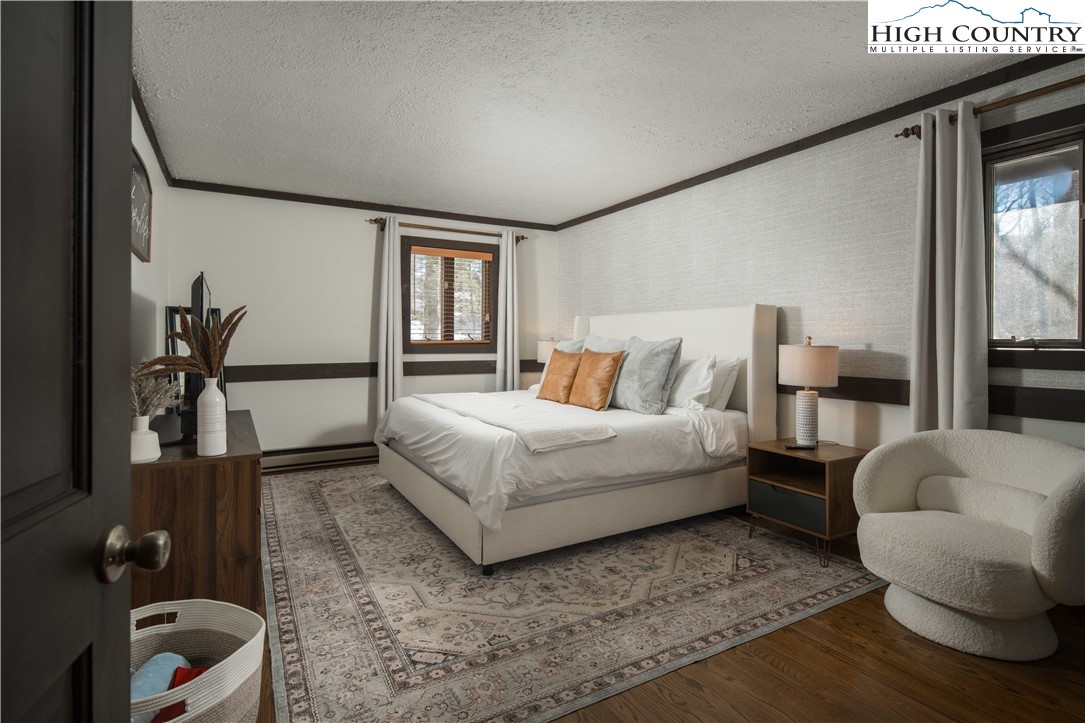 111 Pinnacle Ridge Road Beech Mountain, NC 28604 - Photo 19 of 50 a bedroom with a bed and wooden floor