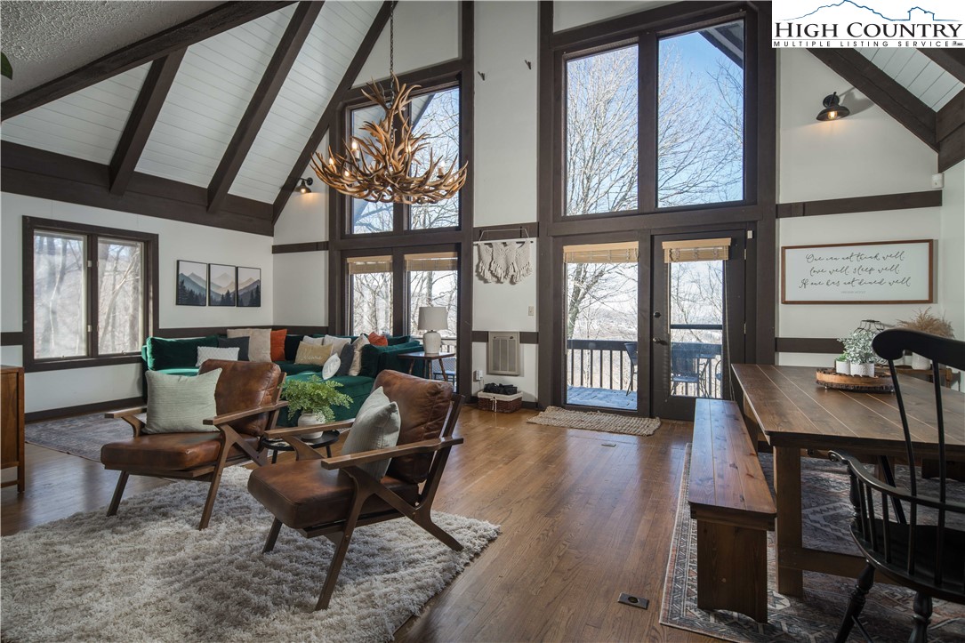 111 Pinnacle Ridge Road Beech Mountain, NC 28604 - Photo 10 of 50 a dining room with furniture large windows and wooden floor