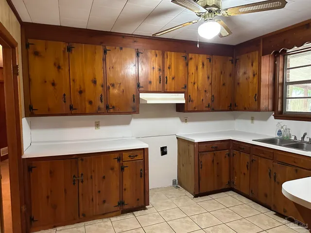 a kitchen with a sink cabinets and appliances