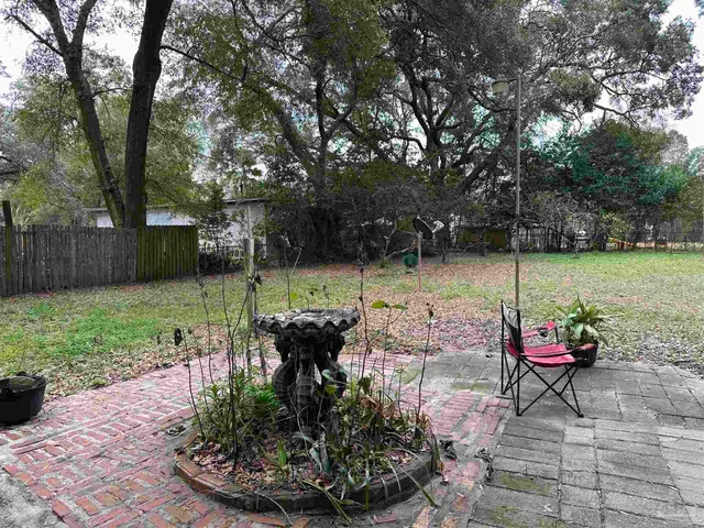 a backyard of a house with table and chairs