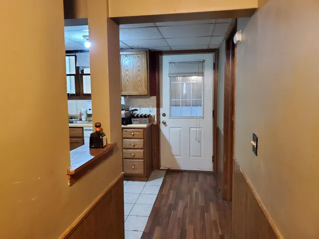a kitchen with a refrigerator a stove top oven and cabinets