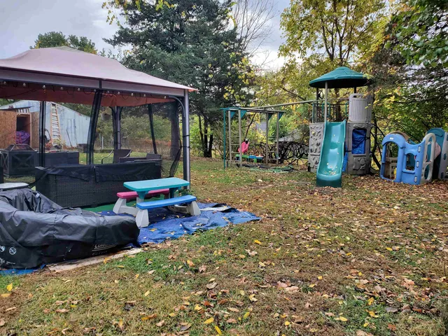 a view of a small house with roof deck