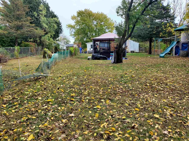 a view of a lake with a bench and trees