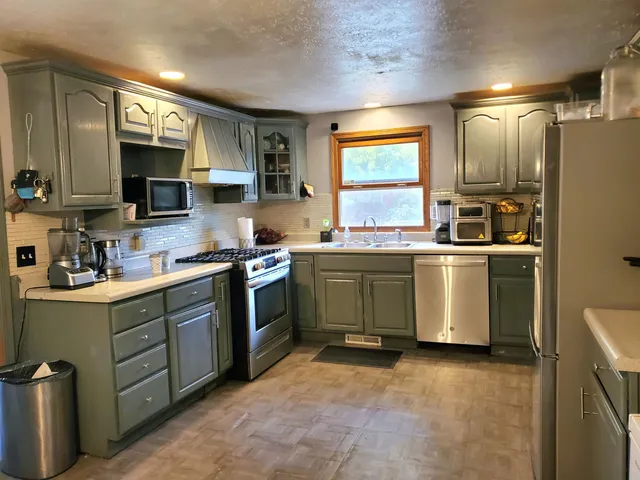a kitchen with a sink stove and refrigerator
