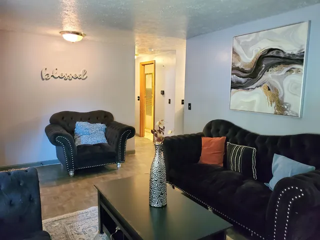 a living room with furniture and a lamp