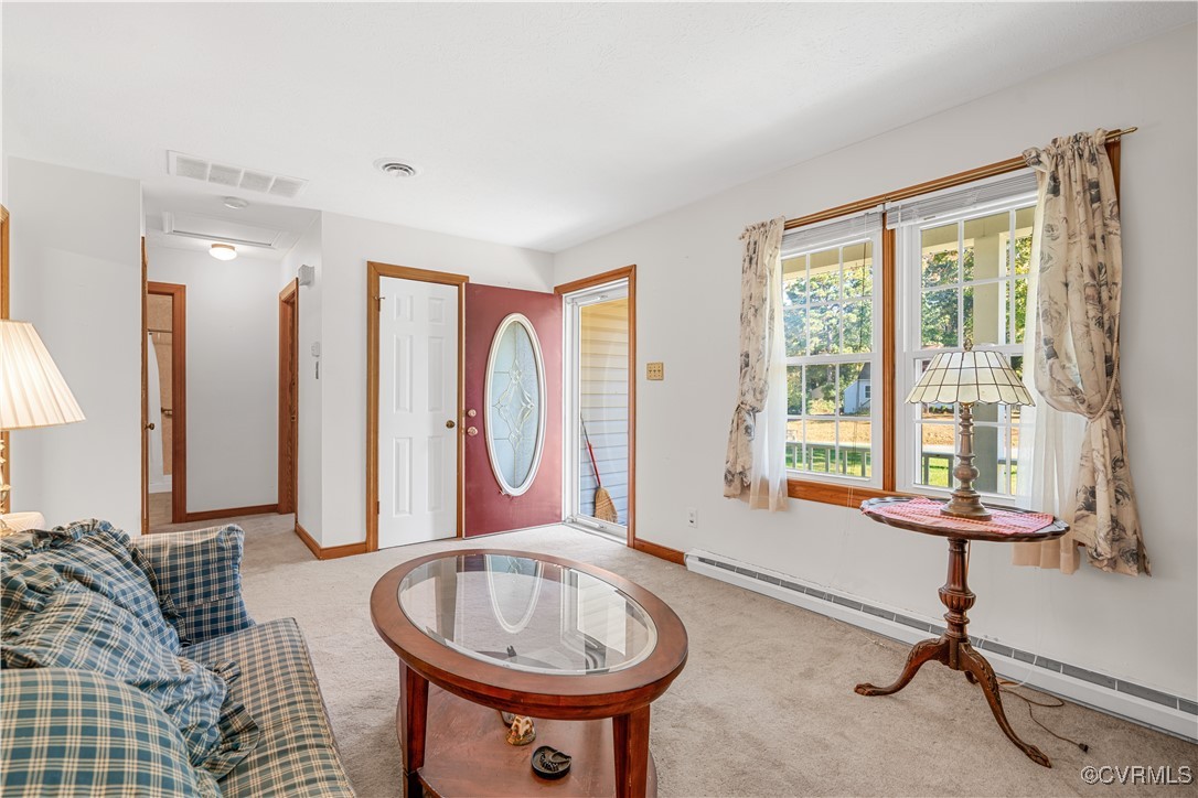 1202 Red Coach Lane Sandston, VA 23150 - Photo 13 of 16 a living room with furniture a window and a chandelier