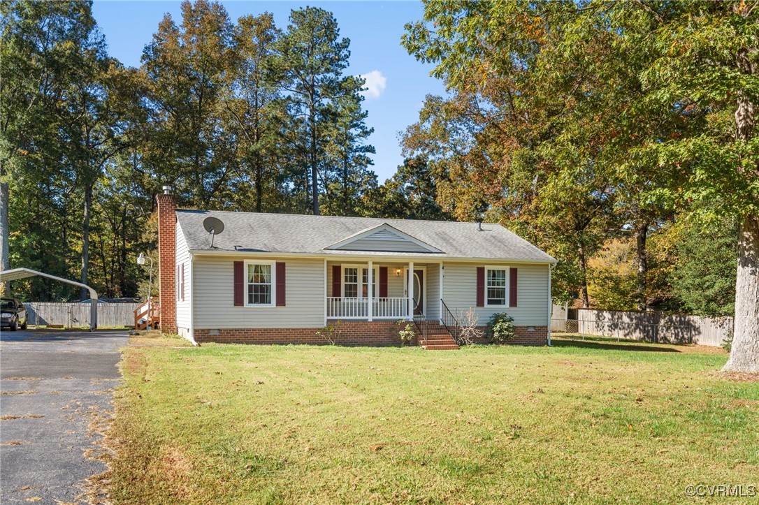 1202 Red Coach Lane Sandston, VA 23150 - Photo 2 of 16 a front view of house with yard and trees around