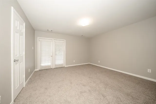 an empty room with a empty space and windows