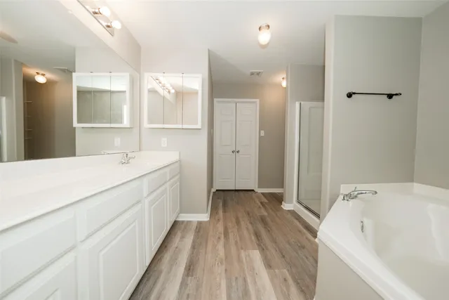 a spacious bathroom with a bathtub and a sink