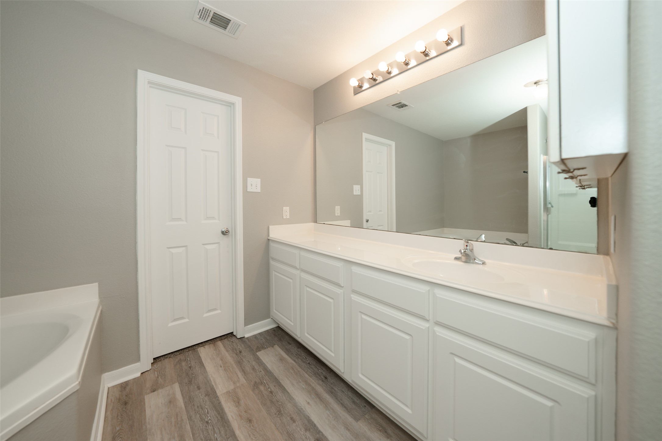 28894 Llano River Loop Spring, TX 77386 - Photo 16 of 33 a bathroom with a double vanity sink and mirror