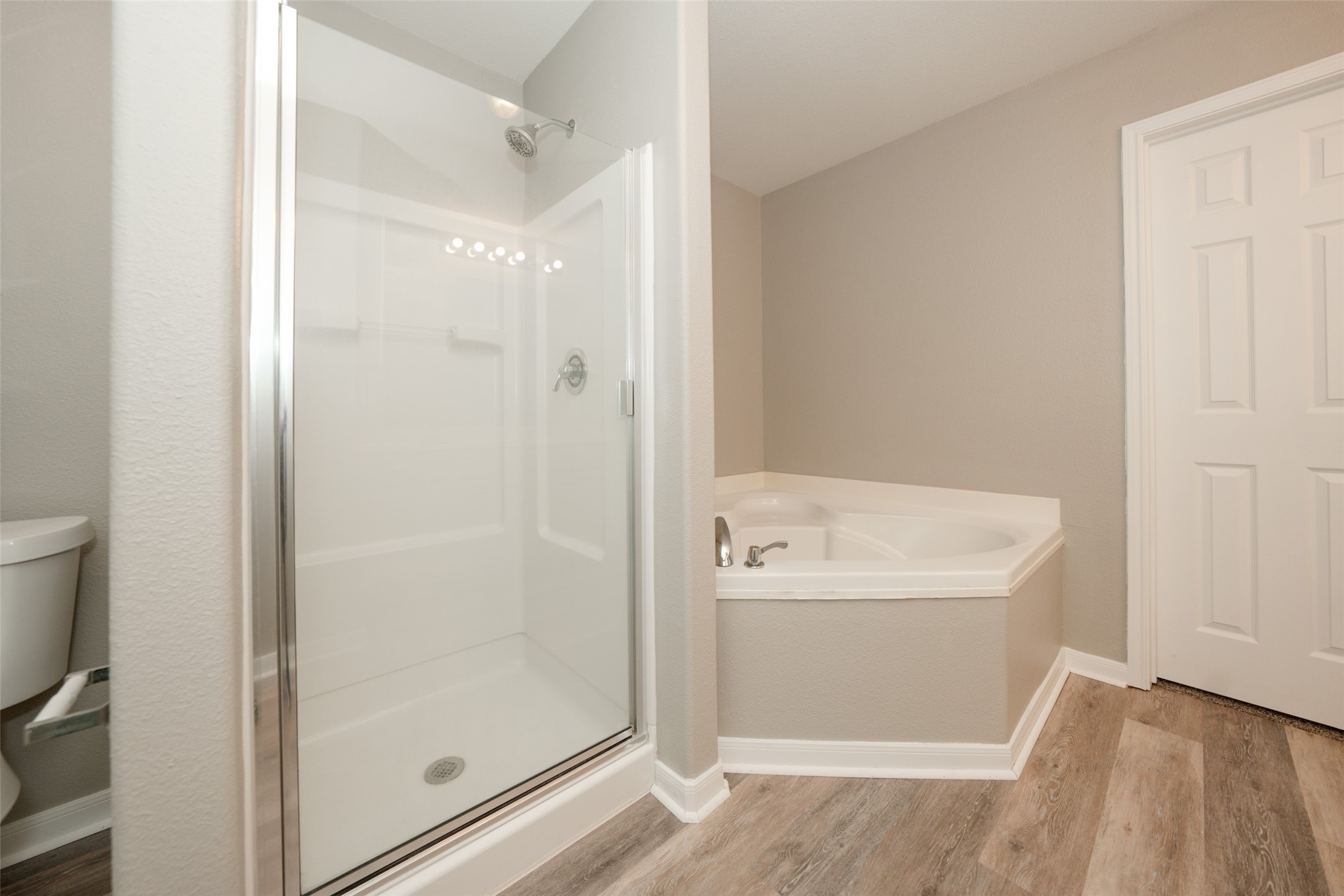 28894 Llano River Loop Spring, TX 77386 - Photo 18 of 33 a bathroom with a bathtub and a shower