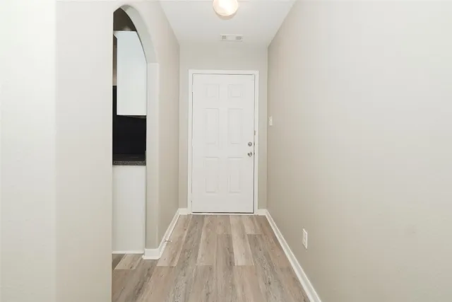 a view of a room with wooden floor
