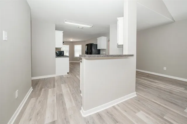 a view of kitchen and wooden floor