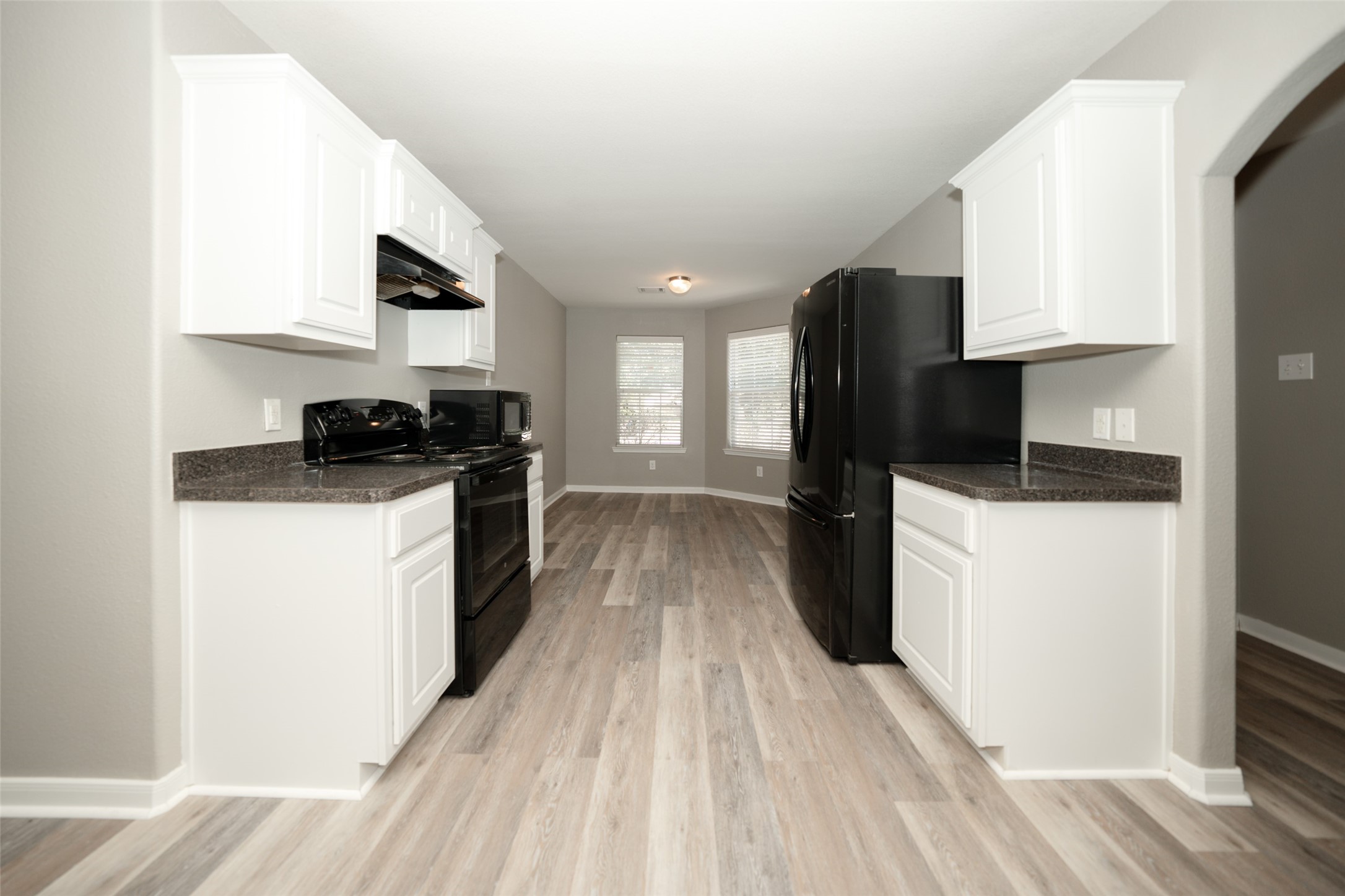 28894 Llano River Loop Spring, TX 77386 - Photo 7 of 33 a kitchen with a sink a refrigerator and cabinets