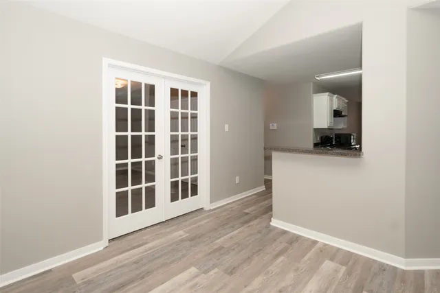 a view of empty room with wooden floor and cabinet