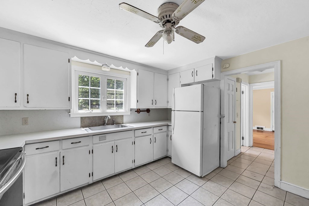 41 Cooley Drive Longmeadow, MA 01106 - Photo 11 of 30 a kitchen with white cabinets and white appliances