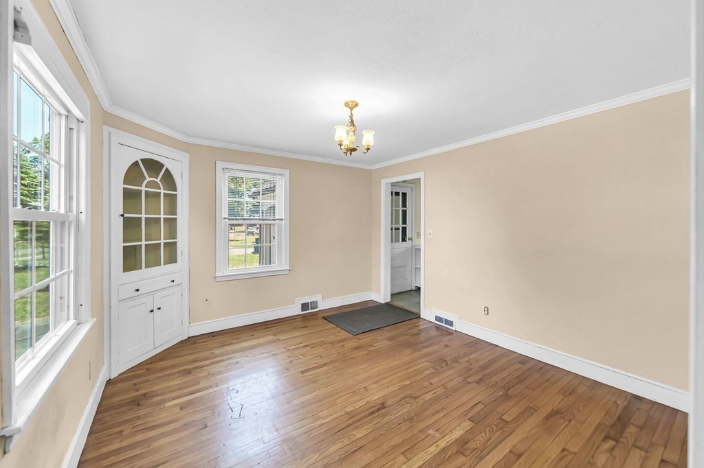 41 Cooley Drive Longmeadow, MA 01106 - Photo 16 of 30 an empty room with wooden floor chandelier and windows