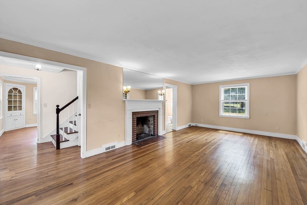 41 Cooley Drive Longmeadow, MA 01106 - Photo 17 of 30 a view of an empty room with wooden floor fireplace and a window