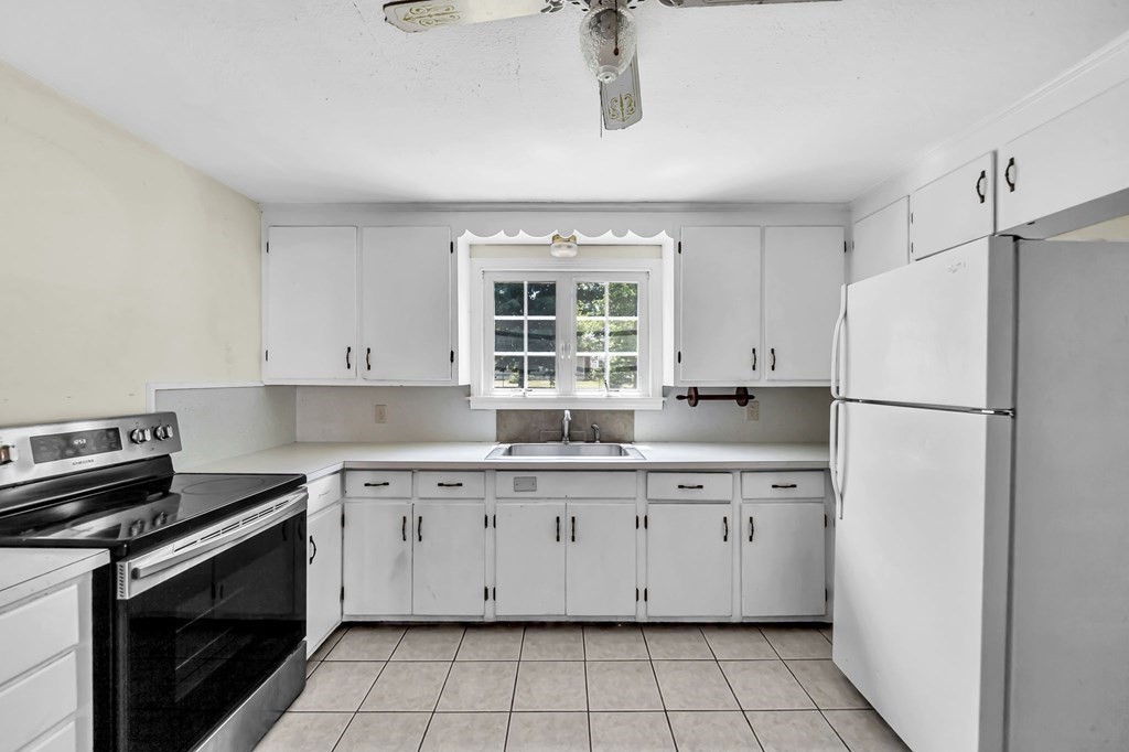 41 Cooley Drive Longmeadow, MA 01106 - Photo 10 of 30 a kitchen with a stove a sink and a refrigerator