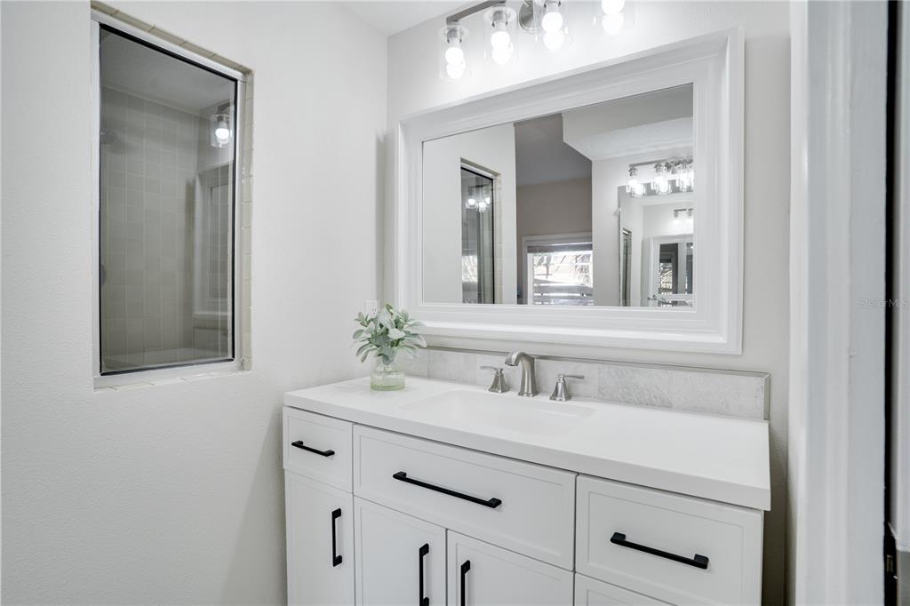 333 12th Avenue Indian Rocks Beach, FL 33785 - Photo 27 of 64 a bathroom with a sink vanity and mirror