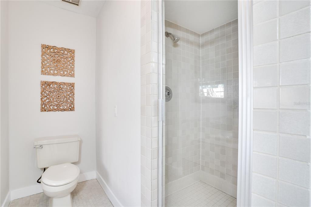 333 12th Avenue Indian Rocks Beach, FL 33785 - Photo 29 of 64 a bathroom with a toilet and a shower